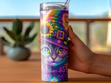 Cat witch wearing a colorful hat and bow tie on a tumbler.