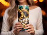 Tumbler with sunflowers and "MAMA" text held by woman.