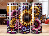 Floral design tumbler with sunflowers, roses, and purple flowers on a wooden table.