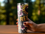 Tumbler with sunflowers, flowers, and "FREE" text, held by a hand.