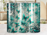 Three tumblers with teal butterflies and ornate green floral designs.