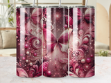 Tumbler with pink butterfly and swirling floral patterns.
