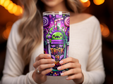 Woman holding a purple Halloween tumbler with candy and a monster design.