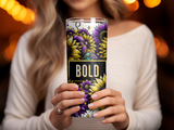 Woman holding a tumbler with "BOLD" and sunflower design.