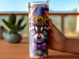 Raccoon wearing a witch hat and sunflower bow tie on a tumbler.