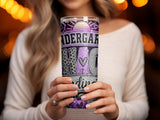 Tumbler with "Kindergarten Grad" text, glitter, and purple apple design.