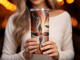 Tumbler with ornate floral and butterfly design in warm colors.
