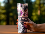 Tumbler with floral pattern and "GLOW" text held by a hand with red nail polish.