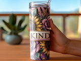 Tumbler with sunflowers, roses, and the word "KIND" on a patterned background.