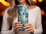 Woman holding a decorative teal butterfly tumbler.