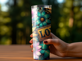 Tumbler with floral pattern and "LOVE" sign held by a hand.