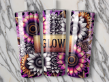 Three tumblers with floral designs and "Glow" text on a marble surface.