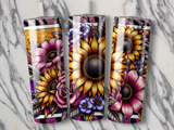 Three tumblers with sunflowers, roses, and purple flowers on a marble surface.