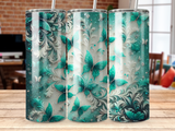 Three tumblers with a teal butterfly and floral design with glitter accents.