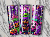 Three Halloween-themed tumblers with trick-or-treat skulls, pumpkins, and candy.