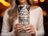 Tumbler with colorful candy and "Get Tricked or Treat Yourself" text.