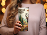 Tumbler with elk, trees, and "Hunting Season" text.