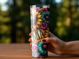 Hand holding a floral patterned tumbler with the word "MAMA" across the center.